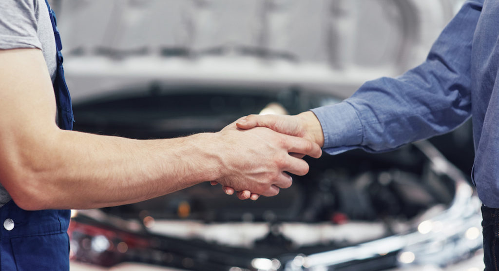 husband car mechanic and woman customer make an agreement on the repair of the car.